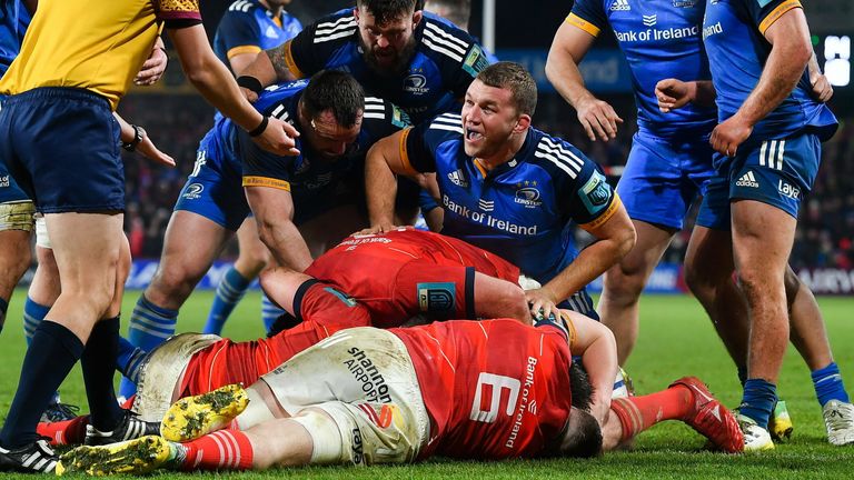 Leinster celebrate Dan Sheehan's (hidden from view) try, as they scored 14 points with a man less